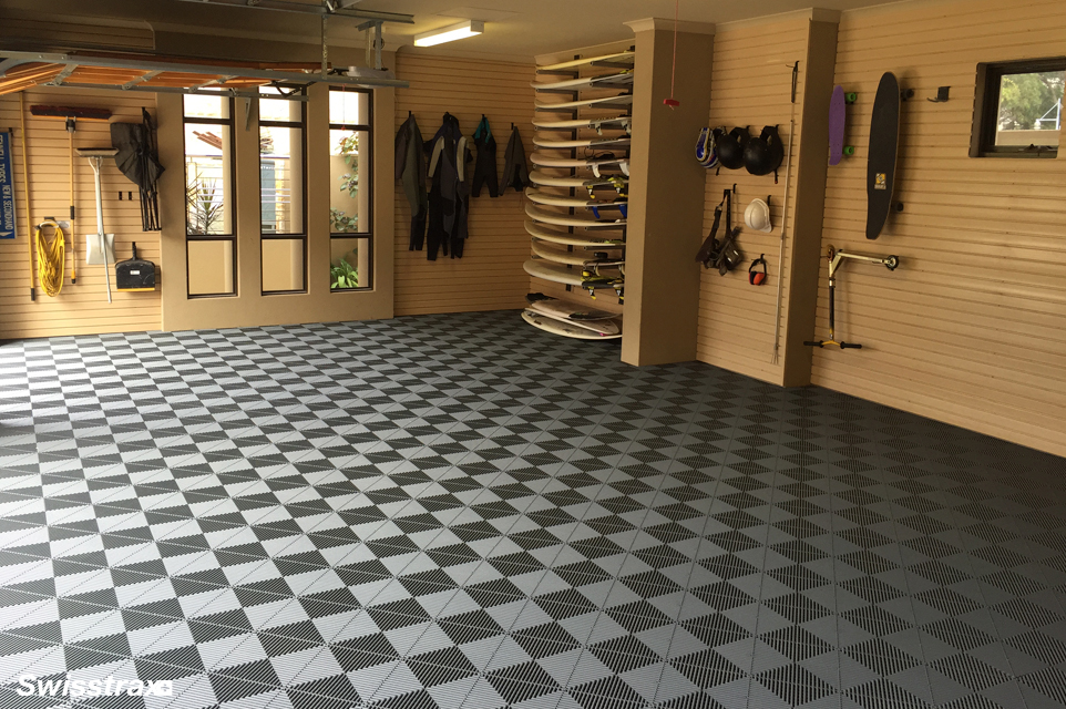 Real neutral gray and black modular tile installation in an organized residential garage