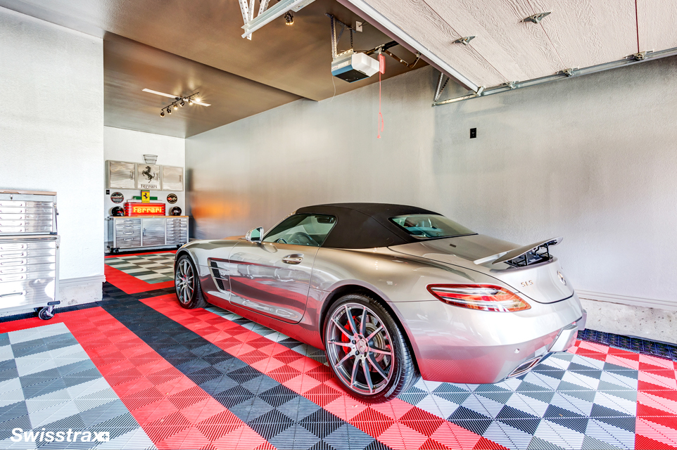 Silver performance car parked on a real red, black, and gray modular garage floor